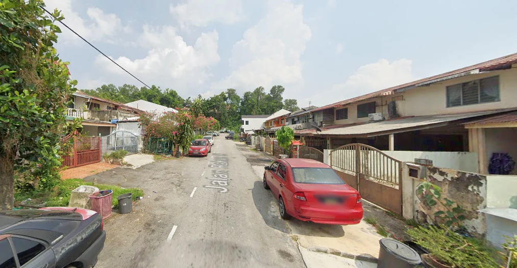 Exterior type: linked terrace house; features: residential street view, two-storey linked terrace houses, paved road, street lined with trees, visible parked cars, front yards with low fences, overhead power lines, clear blue sky; style: traditional.